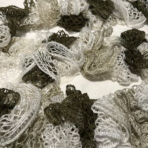 Fun, twirly, loopy knit scarf.